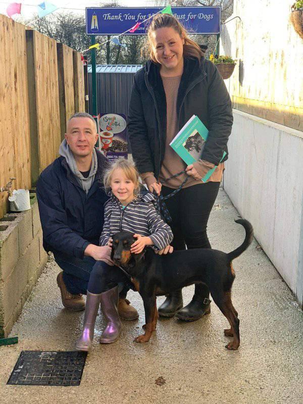 Family and black dog