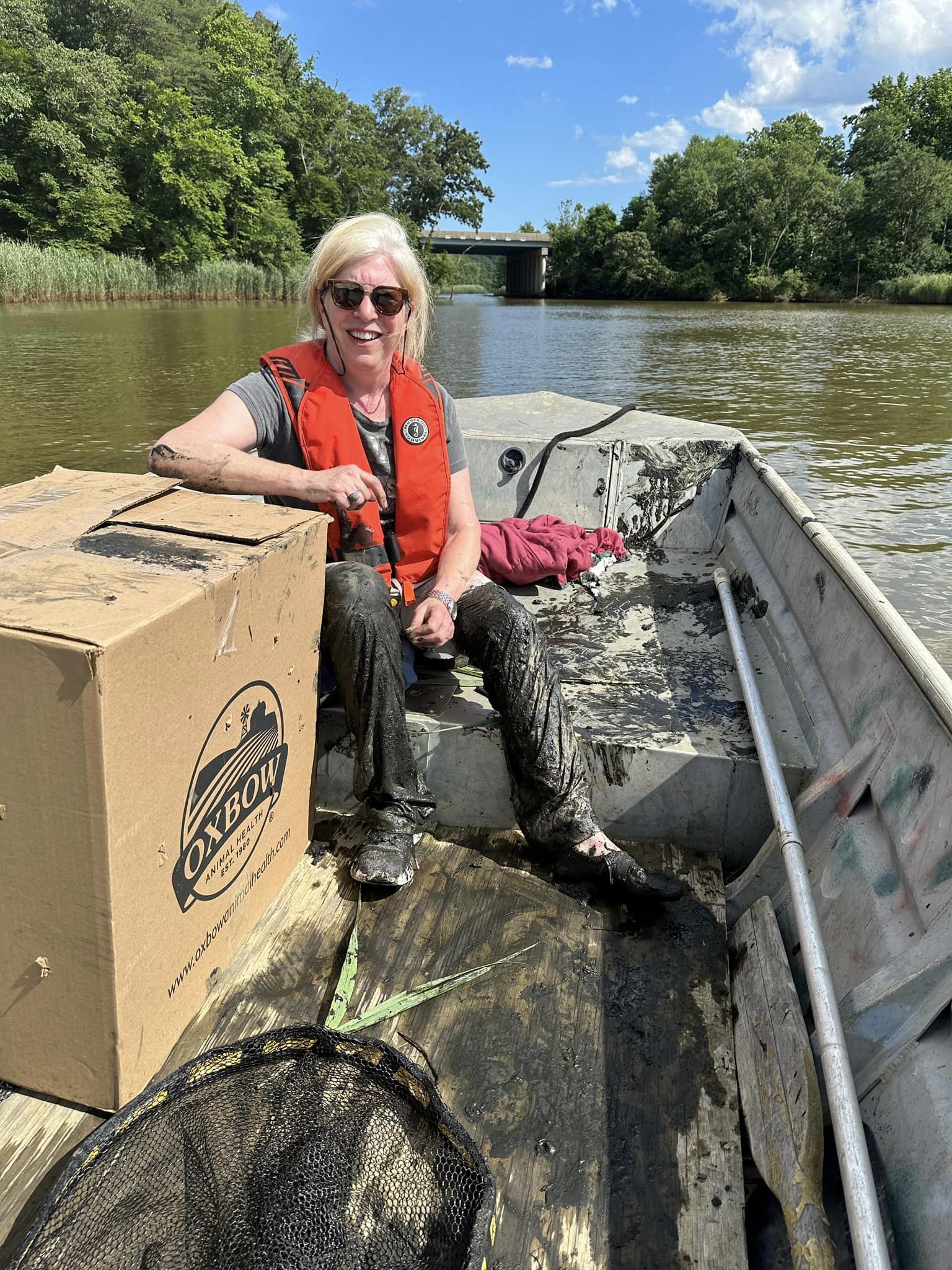 smiling blond woman sitting on the river boat