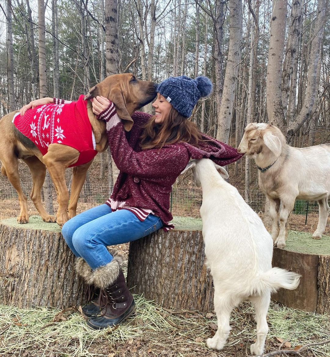 woman, dog and goats