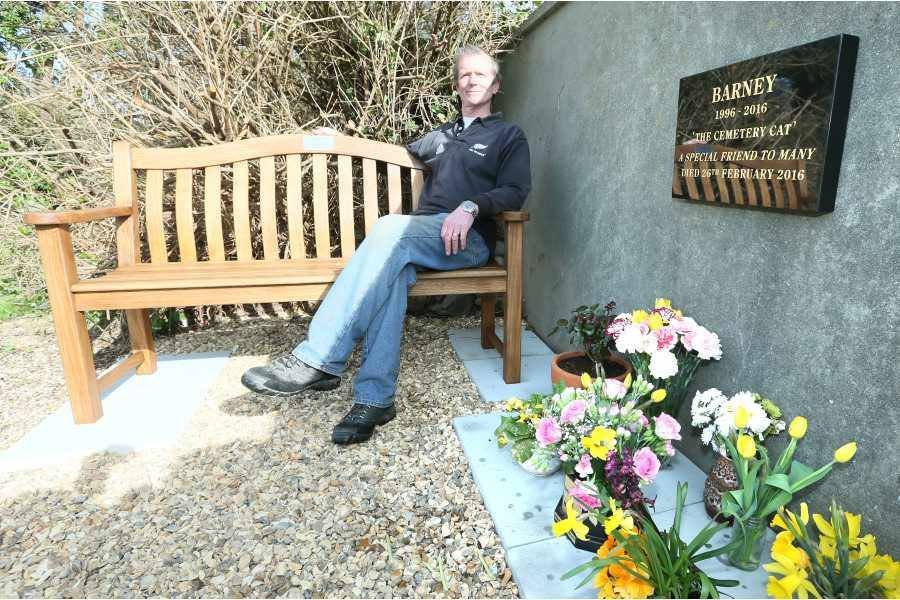 Sexton Alan Curzon sitting on the bench alongside the plaque in memory of Barney, the St Sampson’s cemetery cat. (Picture by Adrian Miller, 14235848)