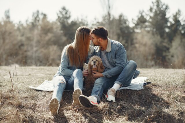 Couple kissing near dog