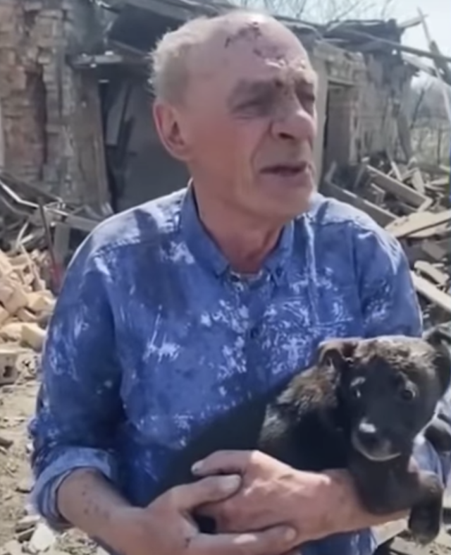 Elderly man holding puppy