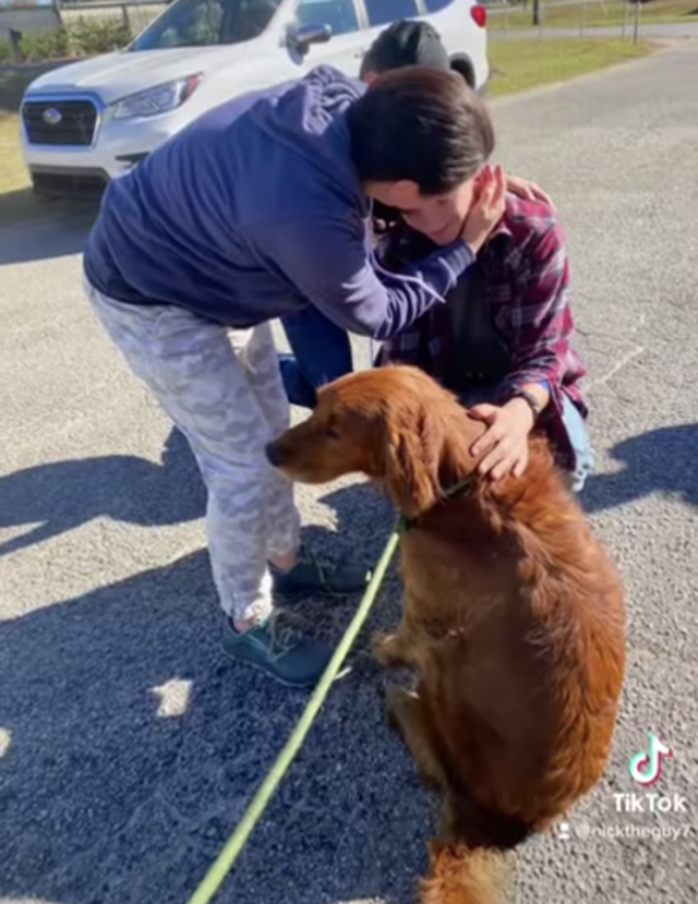 Family hugging near lost dog