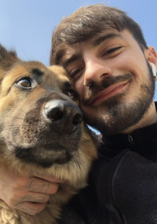 Man cuddling with German Shepherd