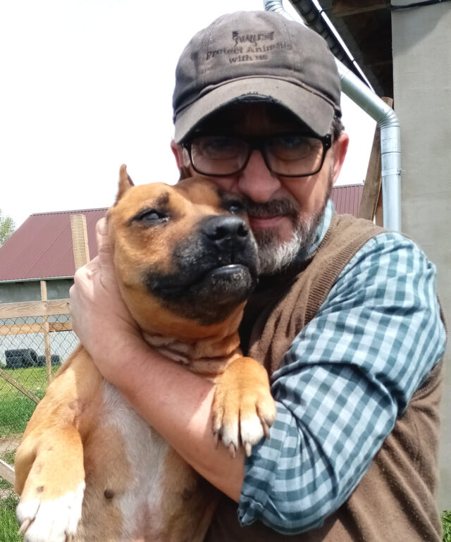 Man hugging stray Pit Bull