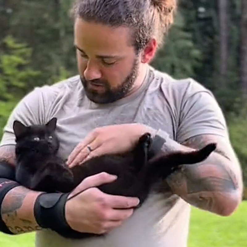 Nathan L. Western Washington, Punkin the black cat, Riley the Yellow Labrador Retriever, cat interrupts Dad's workouts and training, weight toss, hammer toss, Backwoods Highlander, Dad holds black cat