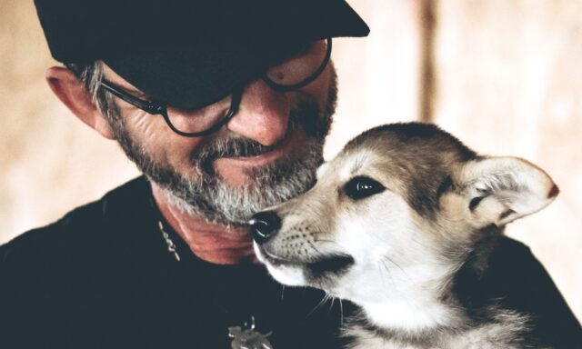 Ukraine man cuddling rescue dog