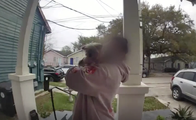 Woman taking Yorkie from porch