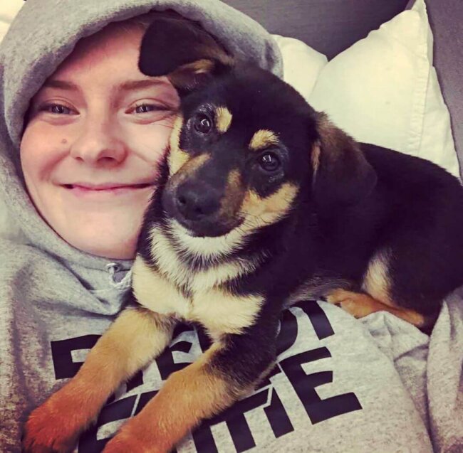 Puppy cuddling with woman